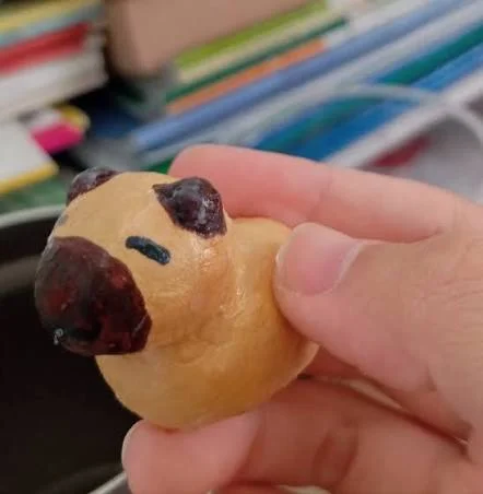applying varnish to clay sculpture